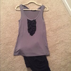 Sleeveless grey blouse with black ruffle